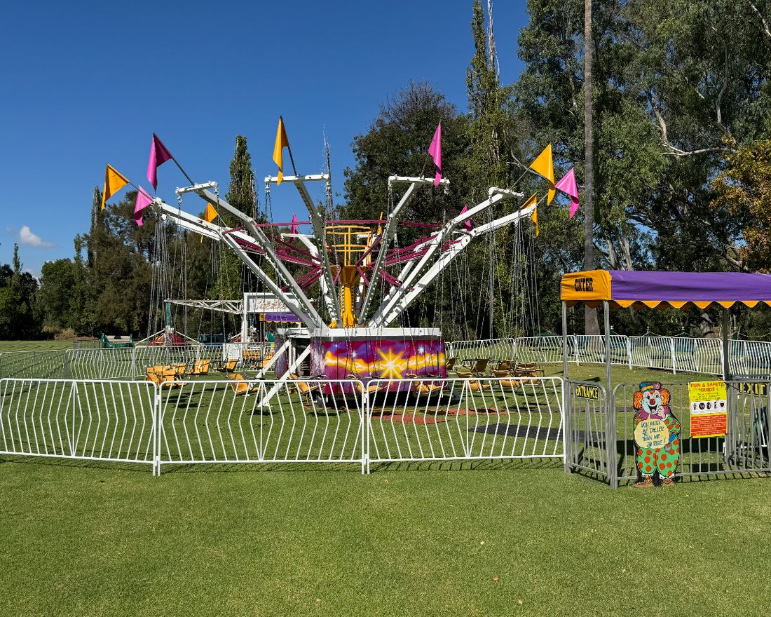 Colourful Aussie Amusements teacup ride set up at an event