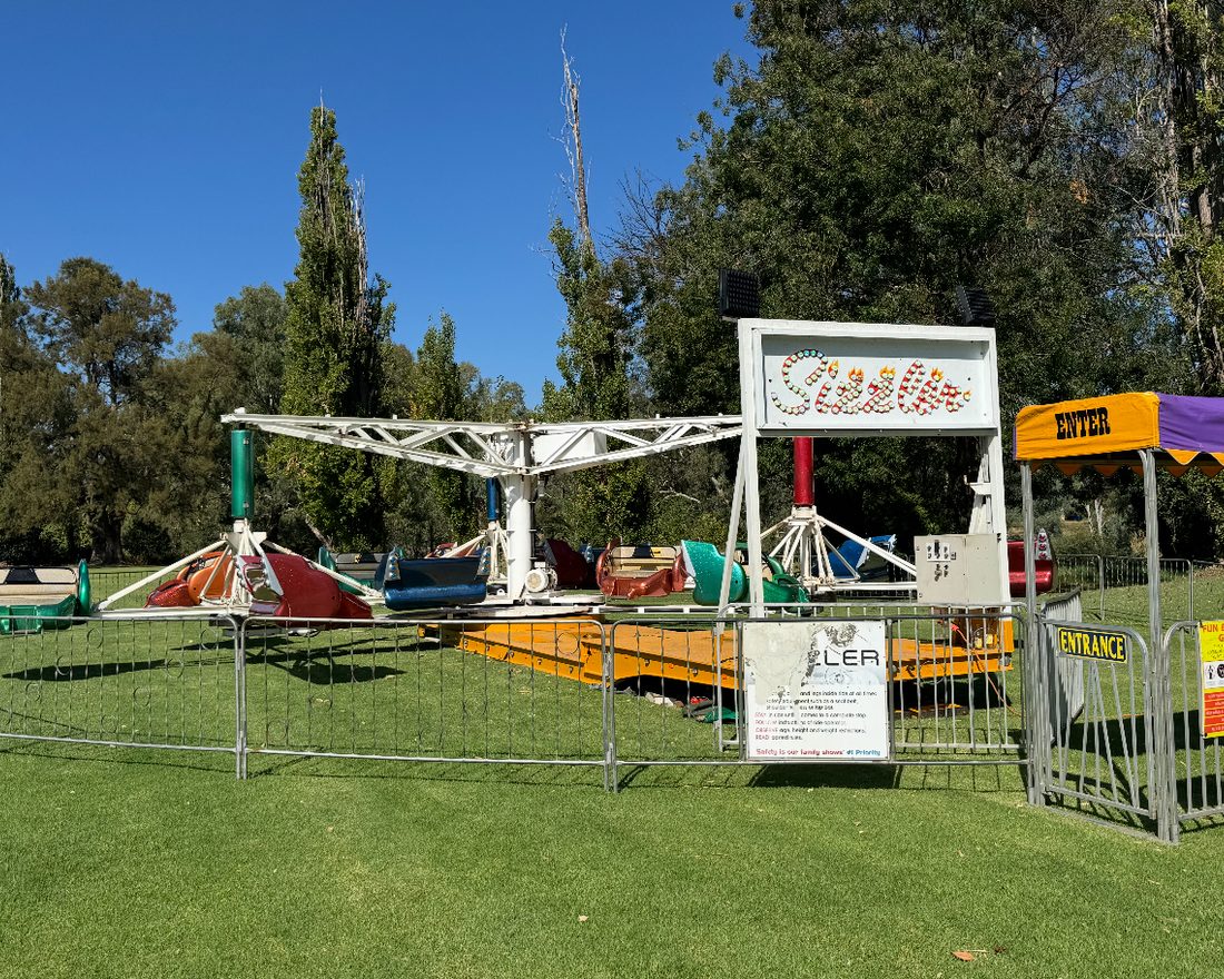 Safety fencing and signage around an Aussie Amusements ride
